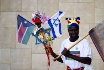 لاجئ من جنوبي في اسرائيل يحمل علمي دولة الجنوب الوليدة وعلم اسرائيل خلال احتفالات اقيمت في تل ابيب في يوم 9 يوليو 2011 للاحتفال باستقلال جنوب السودان (اسوشيت برس)