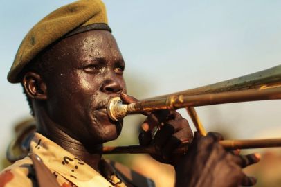 A member of a branch of the SPLA plays a trombone (Getty)