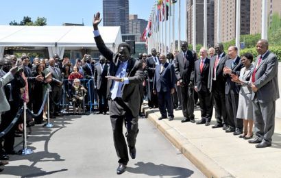 A member of the South Sudan delegation (Ezekiel Lol Gatkuoth) dances after the flag of South Sudan was raised outside the United Nations on 14 July 2011 - (Getty)