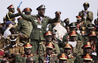 A SPLA Brig. Gen. , back left, celebrates as he and others wait for the start of independence celebrations in Juba, South Sudan, Saturday, July 9, 2011. (AP)