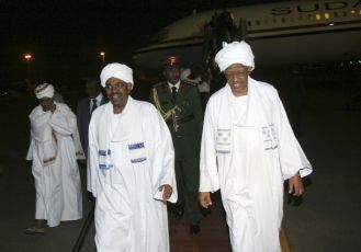 Sudanese President Omar Hassan al-Bashir (from L) is welcomed by Presidential Adviser Nafi Ali Nafi (R) in Khartoum, after returning from China, July 1, 2011 (REUTERS PICTURES)