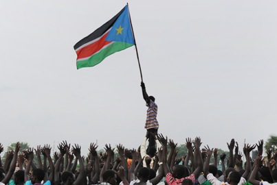 A woman holds the South Sudan flag during a rehearsal of the Independence Day ceremony in Juba July 7, 2011. (photo Paul Bank UNMIS)