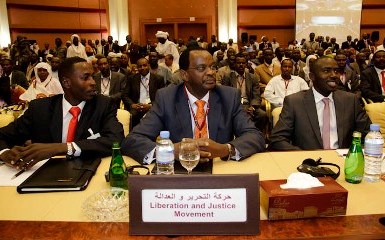 LJM chairman Tijani Al Sissi (C) and his deputy Ahemd Abdel Shafi (L) at the signing ceremony of a peace agreement with the Sudanese government in Doha on 14 July 2011 (photo Olivier Ghassot - UNAMID)