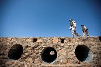 Thai officers of the African Union-United Nations Hybrid Operation in Darfur (UNAMID) walk along the bridge rebuilt by their contingent, in Mukhjar, where the contingent is based, in West Darfur, Sudan (UN Photo/Albert Gonzalez Farran)