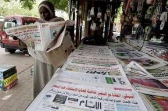A Sudanese woman reads a local newspaper in Khartoum in 2010 (AFP PHOTOS)