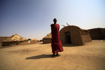 A Sudanese from the south, who stayed in the north for 21 years, stands outside her shelter at Mandela camp, in the outskirts of Khartoum, July 4, 2011 (REUTERS PICTURES)