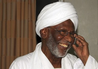 Sudan's Islamist opposition leader Hassan al-Turabi smiles in his home after his release from jail in Khartoum May 2, 2011 (Reuters Pictures)