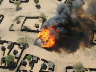 War in Sudan’s western region of Darfur claimed the lives of 300,000 people and displaced 2.7 million, according to UN agencies (An aerial view of a village being burned in Darfur)