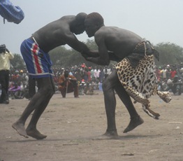 Gai Tiar in a traditional leopard skin, grapples with, Madior Amuom, Jonglei (ST)