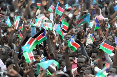 Southern Sudanese watch a giant South Sudan’s flag being raised during the independence  ceremony in the capital Juba on July 09, 2011 (Getty)