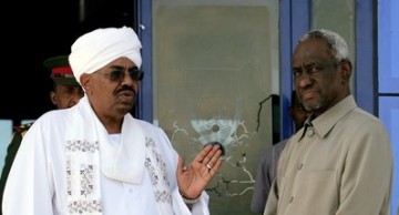 Sudanese President Omar al-Beshir (L) talks to his second Vice President Ali Osman Taha (R) upon the first's arrival from Qatar, on March 31, 2011 at Khartoum airport (Getty Images)