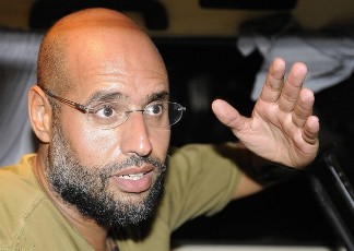 Saif Al-Islam, son of Libyan leader Muammar Gaddafi, gestures as he talks to reporters in Tripoli August 23, 2011 (REUTERS)