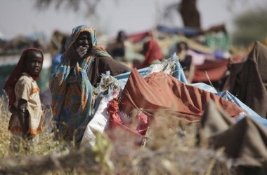 A picture taken on 15 March 2011 shows Internally Displaced Persons who fled their village following clashes between the Sudanese army and rebel movements, look on at the Zamzam camp in North Darfur. (Reuters)