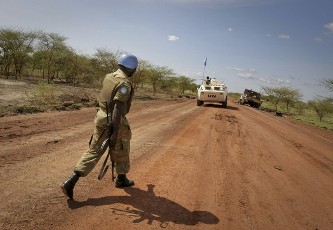 FILE - A patrol from the international peacekeeping operation passes a destroyed UN truck that was part of a convoy transporting northern soldiers out of the Abyei area in the Todach area, north of Abyei town, in this handout picture released by the United Nations Mission in Sudan (UNMIS) May 30, 2011