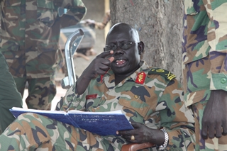 SPLA MG Marial Chanuong receiving a file of collected arms, Cueibet, South Sudan (ST)