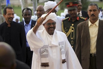 Sudan's President Omar Hassan al-Bashir waves as he arrives to attend the annual Presidential Ramadan breakfast in Khartoum August 17, 2011.