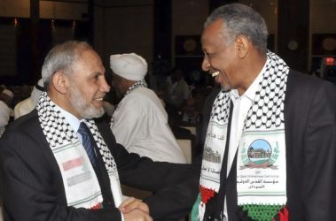 Hamas senior leader Mahmoud Al-Zahar (L) talks to Sudanese Presidential assistant Nafie Ali Nafie during the opening of the eighth Al-Quds (Jerusalem) International Foundation conference in Khartoum March 6, 2011. (Reuters)