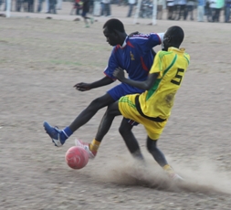 Goozaga team player in yellow and Young Stars player in blue in Rumbek tournament, Lakes state, South Sudan  (ST)