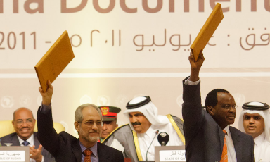Presidential adviser Ghazi Salah Al-Deen (L-R) and LJM leader Al-Tijani El-Sissi hold the text of the DDPD after the signing in Doha on the 14 July (Photo: UNAMID)