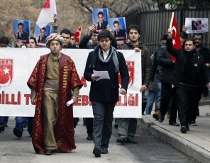 Turkish students, with one at front left wearing clothes of an Ottoman sultan, as they stage a protest outside the French Embassy in Ankara, Turkey, Friday, Dec. 23, 2011 (AP)