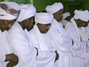 Sudan's president Omer Al-Bashir prays alongside some of his senior aides following his re-election on 26 April 2010 (AP)