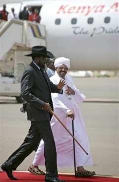 FILE - Sudanese president Omar al-Bashir, right, walks with South Sudan's resident Salva Kiir, left, after his arrival in Khartoum, Sudan, Saturday, Oct.8, 2011 (AP)