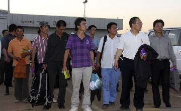 Chinese workers who escaped after being abducted arrive at Khartoum Airport January 30, 2012 (Reuters)
