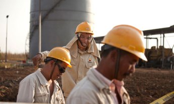 Workers for the China Petroleum Engineering & Construction Corp (CPECC) construct new oil facilities in Sudan. (Photograph: Trevor Snapp/Bloomberg/Getty Images)