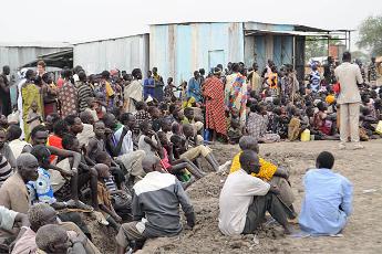 Victims of ethnic violence in Jonglei state in South Sudan wait in line at the World Food Program distribution center in Pibor to receive emergency food rations, last week. Tens of thousands fled their homes after ethnic violence erupted in Pibor county (Michael Onyiego/AP)