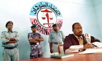 A special judge sits in court in Nyala during the trial of six Sudanese men accused of belonging to the Janjaweed, 30 September 2004 (Reuters)