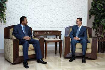 FILE - Sudanese presidential adviser Mustafa Osman Ismail (L) and Syrian president Bashar al-Assad