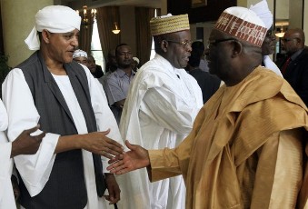 UNAMID Joint Special Representative (JSR) and Joint Chief Mediator Ibrahim Gambari (L) congratulates Musa Hilal, the father of the bride, during the wedding ceremony between Hilal's daughter and Chad President Idriss Deby in Khartoum January 20, 2012 (Reuters)