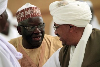 Sudanese President Omer Hassan al-Bashir (R)  talks to UNAMID Joint Special Representative (JSR) and Joint Chief Mediator Ibrahim Gambari during the wedding ceremony between the daughter of tribal leader Musa Hilal and Chad President Idriss Deby in Khartoum January 20, 2012 (Reuters)