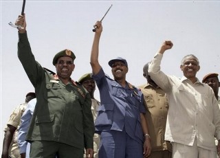 Sudanese President Omar Hassan Ahmed Bashir, left, Defense Minister Abdel Rahim Mohammed Hussein and Nafie Ali Nafie at a Khartoum rally in May (Abd Raouf -  Associated Press)