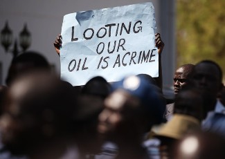 A government supporter holds a banner during a speech by South Sudan's President Salva Kiir outside parliament in Juba January 23, 2012 (Reuters)