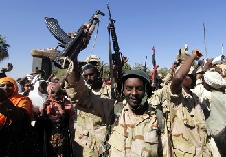 Soldiers_wave_to_government_supporters_during_a_rally_in_support_of_Sudan_s_armed_forces_in_front_of_the_military_headquarters_in_Khartoum_December_28_2011_Reuters_.jpg