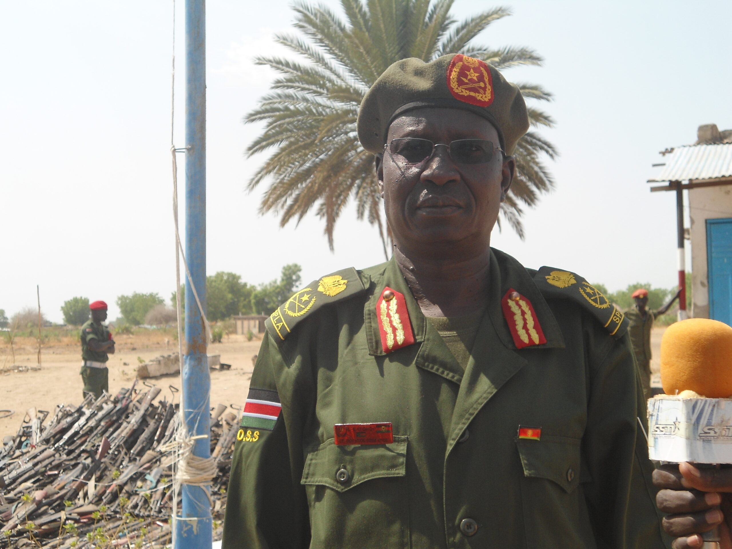 The head of disarmament operation in Jonglei State, Gerenal Kuol Dim Kuol, standing infront of the rifles collected from  Waat, Uror County. 28 March 2012 (ST)