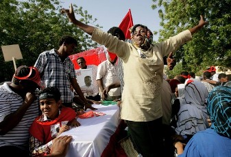 A Sudanese woman gestures as people mourn over the coffin of Ibrahim Nugud, late leader of Sudan's Communist party, during his funeral in Khartoum on March 25, 2012 (GETTY)