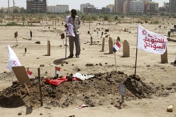 A man stands near the grave of Mohamed Ibrahim Nugud, head of Sudan's Communist Party, in Khartoum March 25, 2012