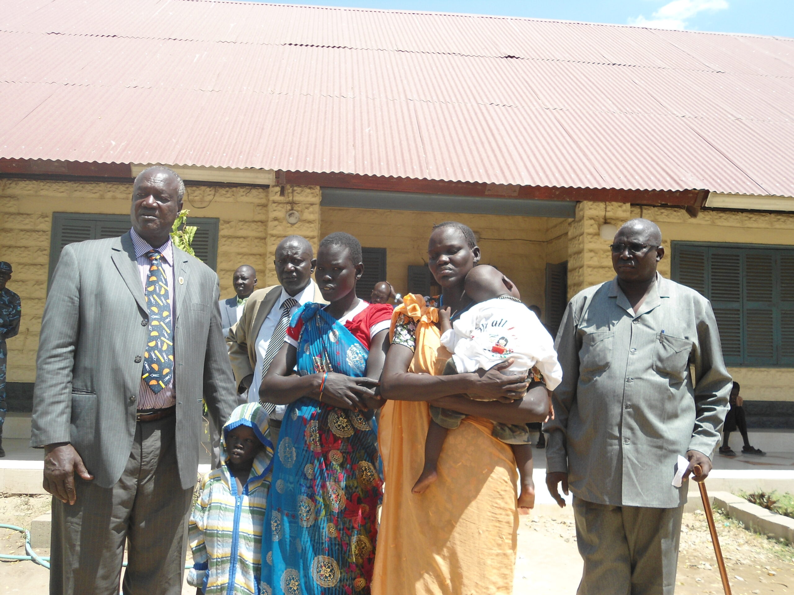 Left to right: Jonglei State Governor Kuol Manyang, the Minister of Legal Affairs Mayen Oka, standing behind newly recovered women Yom Machok and Tibatha Nyakau Chol and State Minister of Local Goverment Diing Akol Diing, in front of the governor's office in Bor. March 23, 2012 (ST)