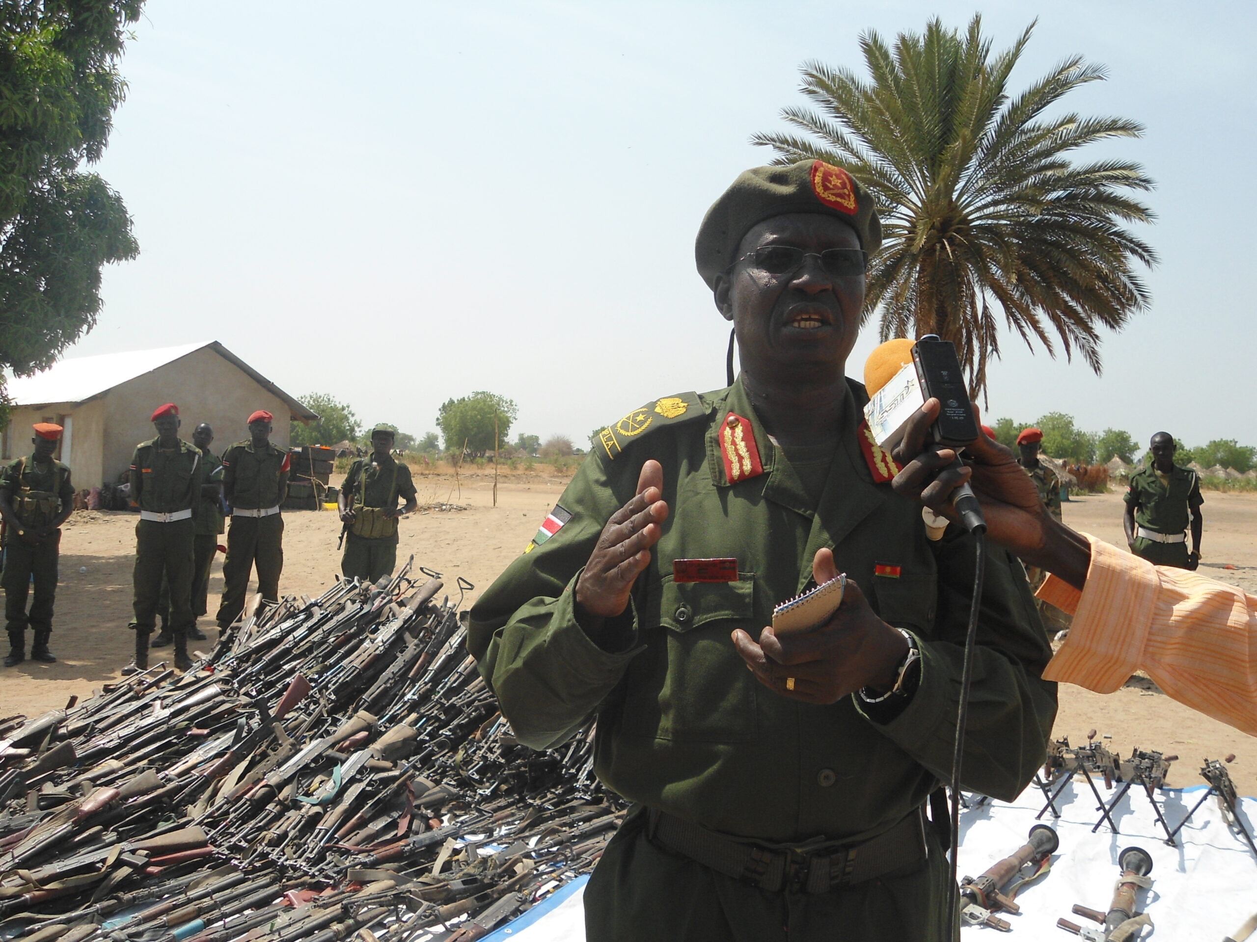 The head of disarmament operation in Jonglei State, Gerenal Kuol Dim Kuol, standing infront of the rifles collected from Waat, Uror County. 28 March 2012 (ST)