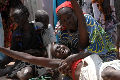 In this UN file photo of 2009 tribal attacks in Jonglei, the family of a SPLA officer who was killed during the fighting in Duk Padiet mourn him at a funeral at the family homestead.