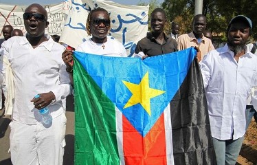 Protestors march with the flag of South Sudan, appealing for peace and an end to tribal violence in South Sudan in the country's capital Juba on January 9, 2012. (Getty)