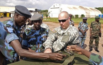 FILE - US soldiers assist Ugandan Airforce personnel as they package food supplies at a military airbase in Entebbbe, Uganda on December 6, 2011 (AFP)