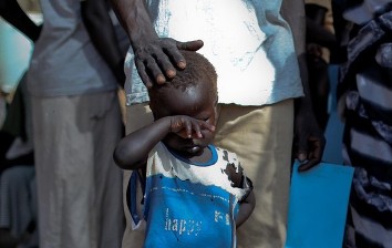 A boy who fled a war across the border in Sudan's Blue Nile state waits in a queue outside a clinic in Doro refugee camp, March 9, 2012 (Reuters)