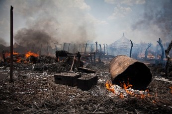 A picture taken on April 14, 2012 shows burned houses in Bentiu after a bomb fell beside a car market (AFP)