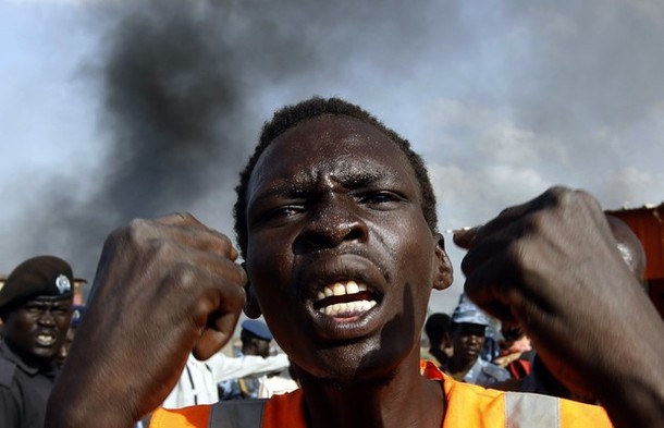 A man gestures at a market burnt in an air strike by the  Sudanese air force in Rubkona near Bentiu April 23, 2012. (Reuters/Goran Tomasevic)