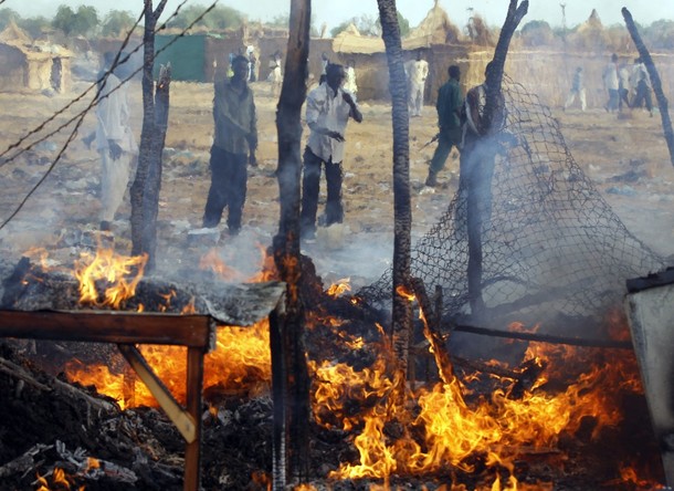 Men look at a market destroyed by an air strike by the Sudanese air force in Rubkona near Bentiu April 23, 2012 (Reuters/ Goran Tomasevic)