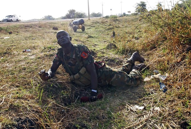 A SPLA soldier looks at warplanes as he lies on the ground to take cover beside a road during an air strike by the Sudanese air force in Rubkona near Bentiu April 23, 2012 (Reuters/ Goran Tomasevic)