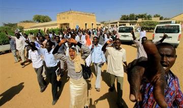 File - Sudanese students shout slogans during a protest against the visit of Darfur mediators from Qatar and the UN outside the University of Zalinge
